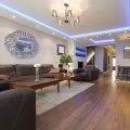 Several examples of indoor lighting being used within a modern living room