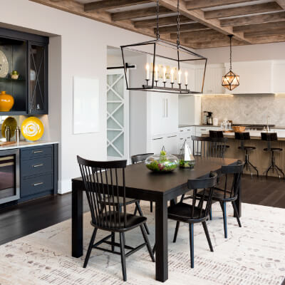 Modern indoor dining room lighting used to liven and brighten up a domestic dining room using chandeliers.