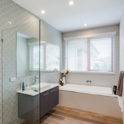 Ceiling lights being used in a modern home bathroom to provide warm lighting