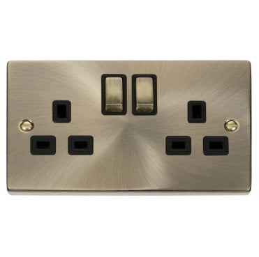 VPAB536BK Decorative Double Ingot Switched Socket with Black Insert in Antique Brass